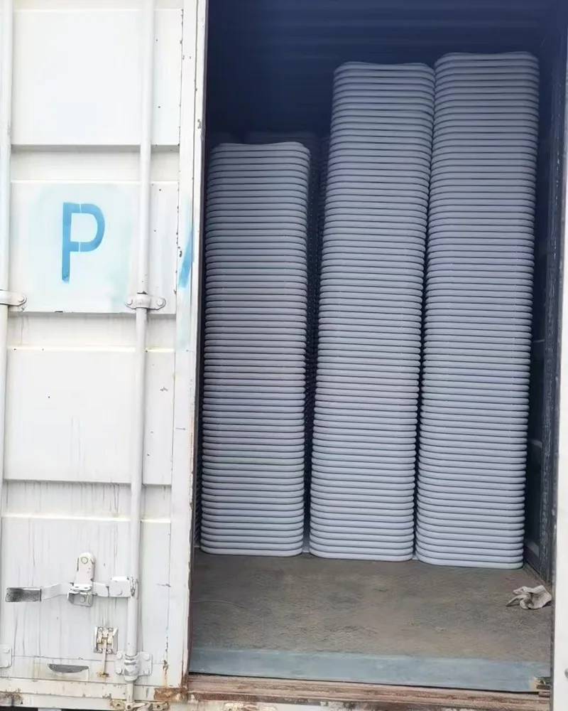 White folding chairs stacked inside a shipping container